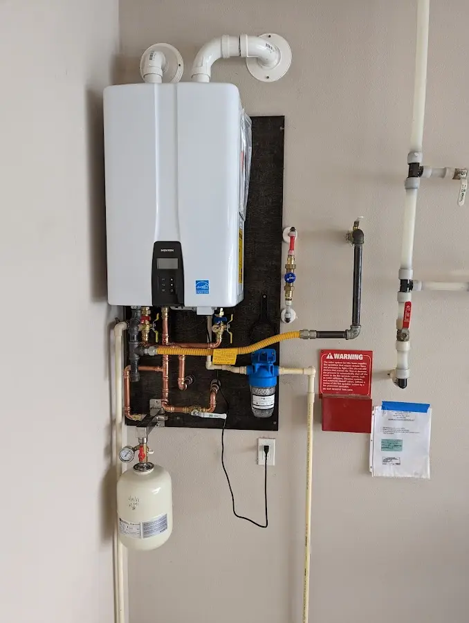 Professional plumber installing copper piping in a Paradise Hills home